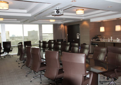 Conference room at Kazar’s Electric, Inc. with modern furniture and city view, ideal for meetings and presentations.
