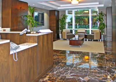 Welcoming reception area of Kazar’s Electric, Inc. with modern seating, plants, and a sleek front desk.