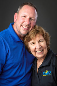 David Kazar and a team member smiling, showcasing camaraderie and Kazar's Electric’s commitment to quality service.