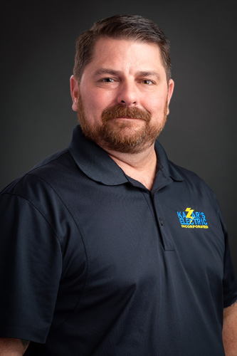 Ryan Hode, a Kazar’s Electric project manager, in a dark polo shirt with logo, exudes professionalism.