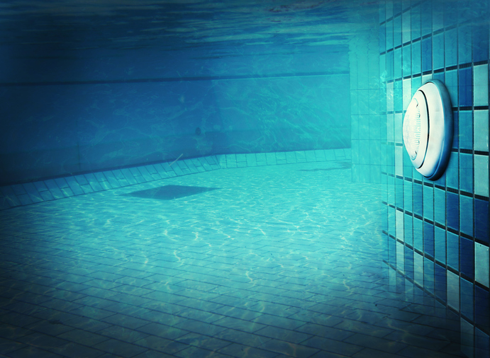 Underwater pool scene with serene blue tiles, showcasing Kazar's Electric's expertise in pool equipment connections.