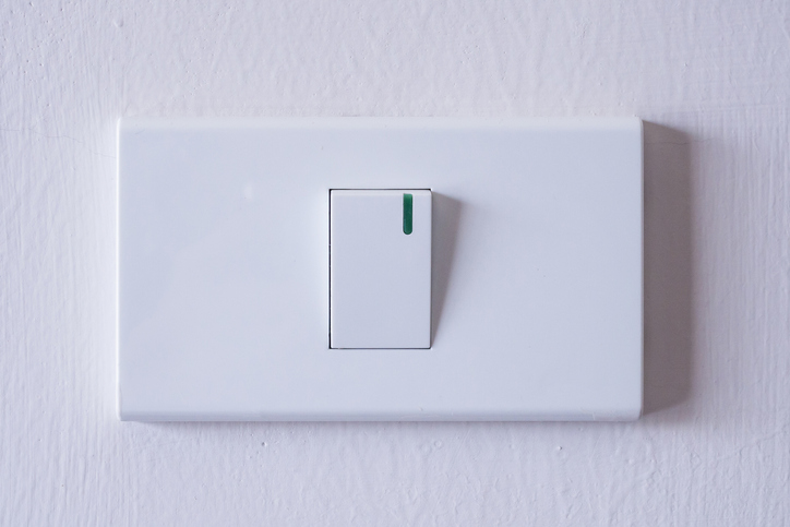 White toggle light switch on a wall, representing residential electrical options and installation services by Kazar’s Electric.