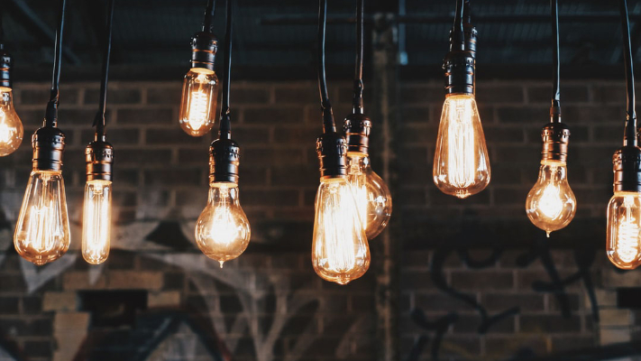 Hanging vintage-style light bulbs illuminating a commercial space, emphasizing the importance of effective commercial lighting services by Kazar's Electric.