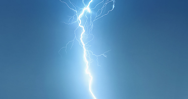 Lightning bolt against a blue sky symbolizing power surges and electrical issues relevant to business operations.