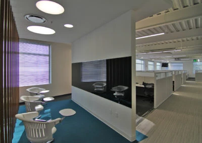 Modern office space with lounge seating and glass partitions for Kazar’s Electric, Inc.'s project portfolio.