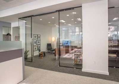 Modern office space featuring glass walls, stylish seating, and artwork, perfect for Kazar's Electric's projects portfolio.